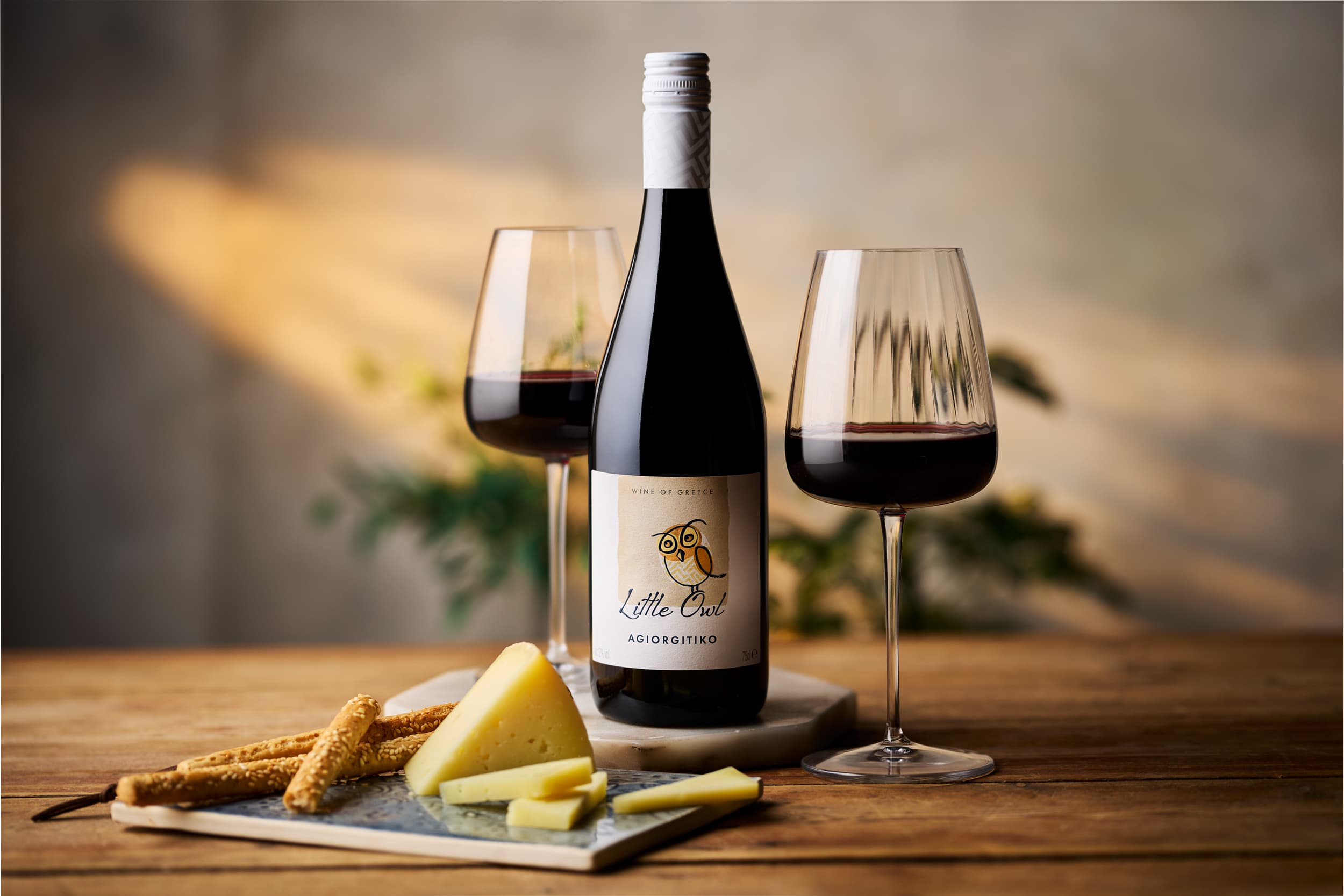 Little Owl Agiorgitiko wine with cheese board and breadsticks